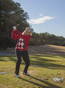 Our "Total joint experience" helps joint replacement patients like Gina C., Southport.Gina C. Southport outside, playing golf on a golf field.