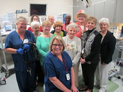 Committee of the Dosher Volunteers funded the purchase of a colonoscope in the amount of $16,000. Posing with the device are Kathy Watts, RN; volunteers Lisa Len, Arlyne Fetterer, Gerri Robinson, Bill Blair, Peg Blair, Verda Darrell, Mary Ann Van Meter, Ann Hollingsworth, DeVota Vereen and Pat Stewart. Seated is Surgical Services Director Peggy Beverly, RN.