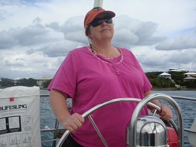 Picture of Penny Smith, Wilmington smiling on a sailboat.