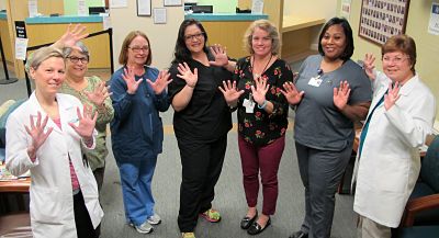 Amanda Reynolds, FNP, Renee McCluskey, Wendy Perretta, Amanda Northcutt, Trish Beatini, Lanette Smith, and Dawn Sampson, PA-C—some of the staff at Dosher Medical Plaza—give the “10-year” hand sign to mark the anniversary of the first Dosher Medical clinic.Amanda Reynolds, FNP, Renee McCluskey, Wendy Perretta, Amanda Northcutt, Trish Beatini, Lanette Smith, and Dawn Sampson, PA-C some of the staff at Dosher Medical Plaza give the "10-year" hand sign to mark the anniversary of the first Dosher Medical clinic.
