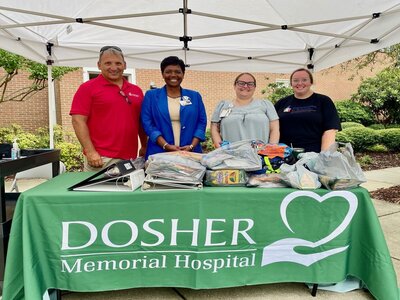 Pictured L – R: Communities In Schools Success Coach Bryan Mills, Dosher CEO Lynda Stanley, Communities In Schools Success Coach Corri Proctor, and Dosher Organizational Development Specialist Megan Shrewsbury manage the school supply drop off station outside of the hospital front entrance.Pictured L – R: Communities In Schools Success Coach Bryan Mills, Dosher CEO Lynda Stanley, Communities In Schools Success Coach Corri Proctor, and Dosher Organizational Development Specialist Megan Shrewsbury manage the school supply drop off station outside of the hospital front entrance.