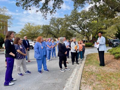 Dosher CEO Lynda Stanley, far right, leads the Pause to Give Life flag raising ceremony on April 1.Dosher CEO Lynda Stanley, far right, leads the Pause to Give Life flag raising ceremony on April 1.