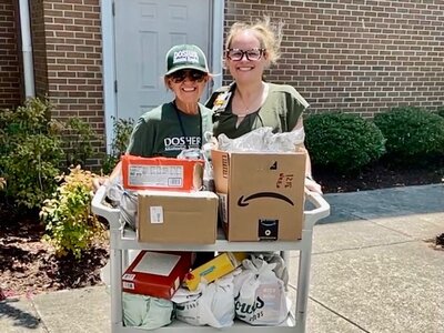 Director of Marketing and Community Relations, Ilene Evans, left, and Megan Shrewsbury, Organizational Development Specialist and Chair of the Employee Engagement Committee, right, stood curbside at Dosher on July 8th to collect food from community members.Director of Marketing and Community Relations, Ilene Evans, left, and Megan Shrewsbury, Organizational Development Specialist and Chair of the Employee Engagement Committee, right, stood curbside at Dosher on July 8th to collect food from community members.