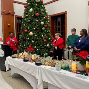 Dosher tree lighting ceremony with large Christmas tree and staff